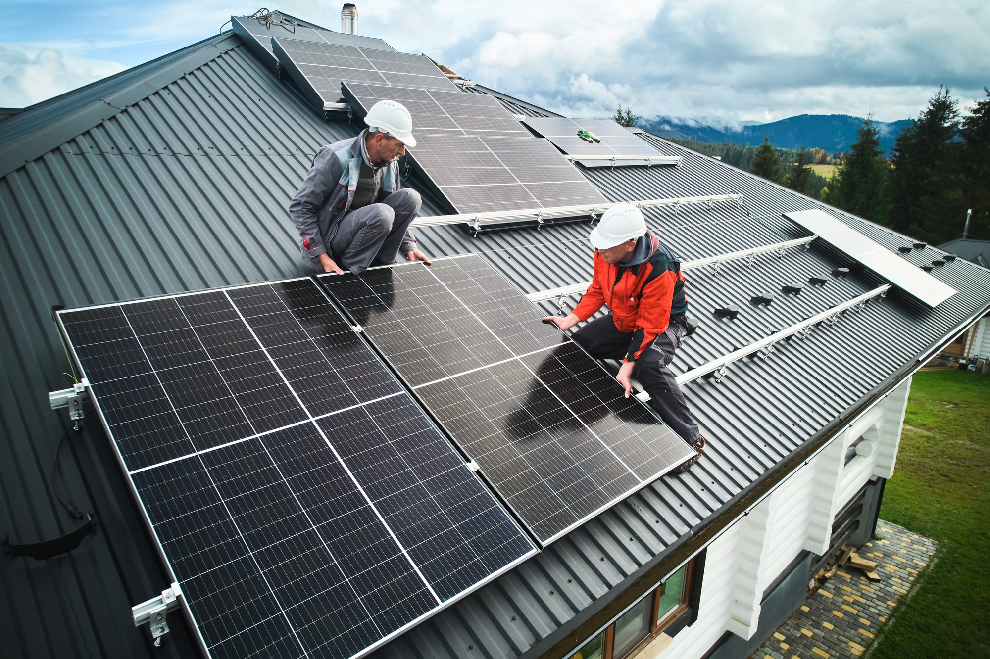 men-workers-installing-solar-panels-on-roof-of-house-.jpg